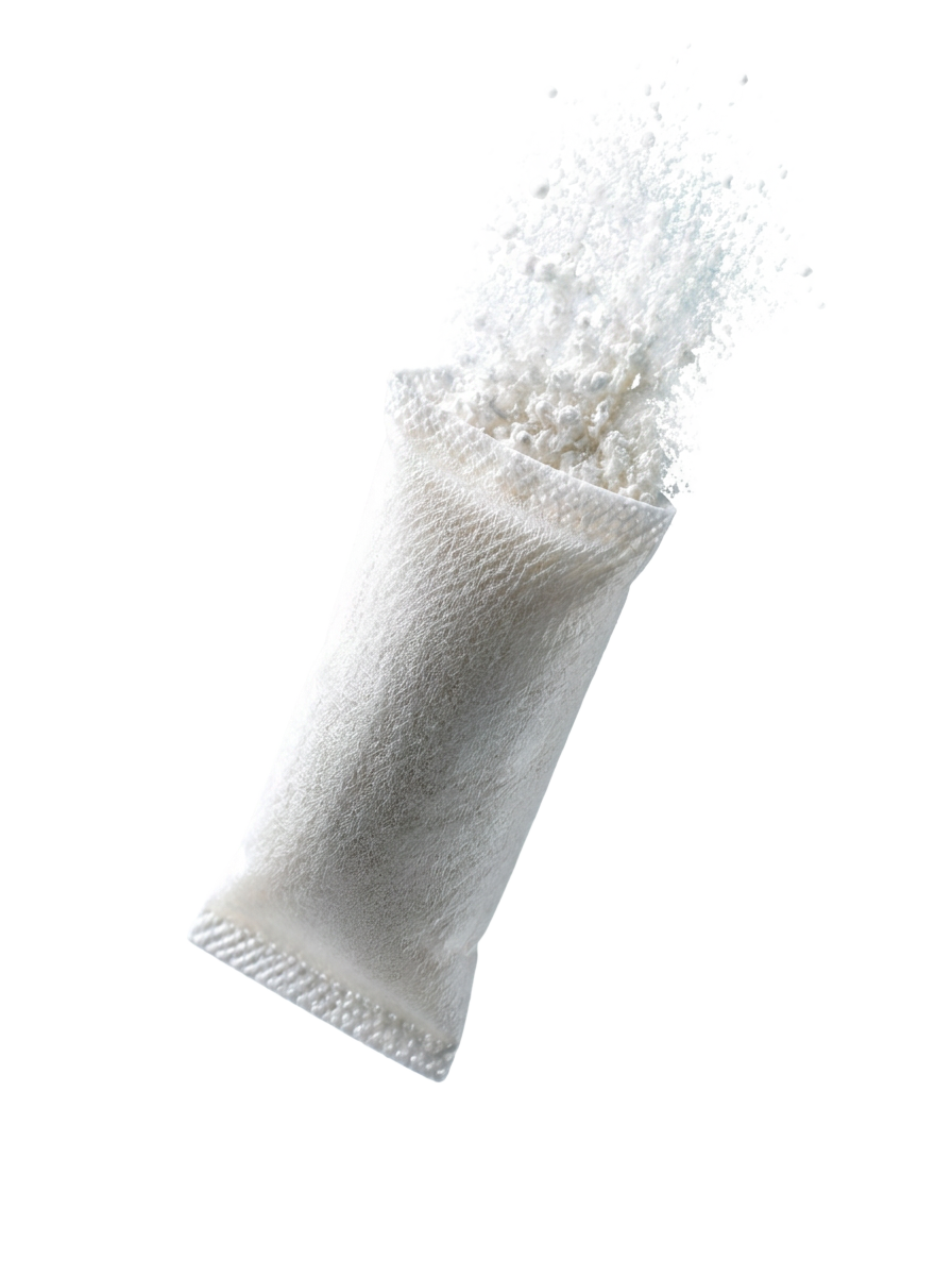 White nicotine pouch with fine powder rising from the top, photographed against a soft clinical gradient background